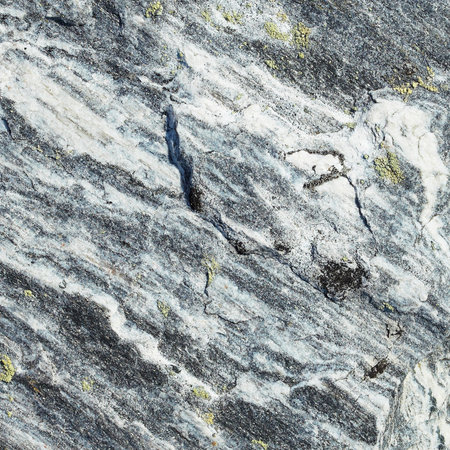 Rough surface of a grey granite rock