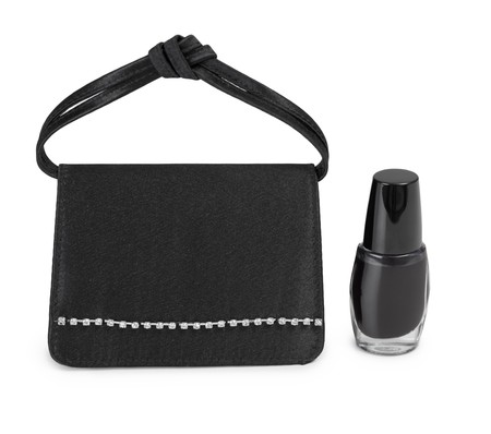 Small ladies' handbag and cosmetics vial on a white backgroundの写真素材