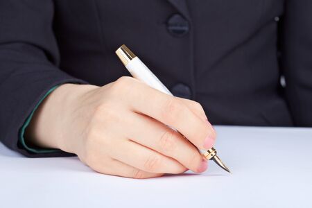 The person undersigns an golden ink penの写真素材