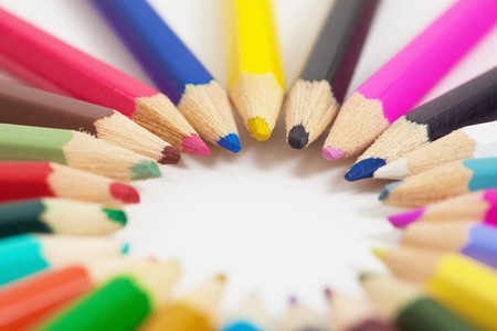 Several children's colored pencils arranged in a circleの写真素材