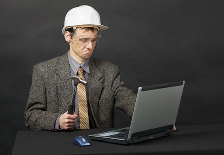 The man intends independently to repair the computerの写真素材