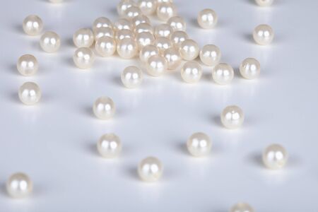 The pearls scattered on a light surfaceの写真素材