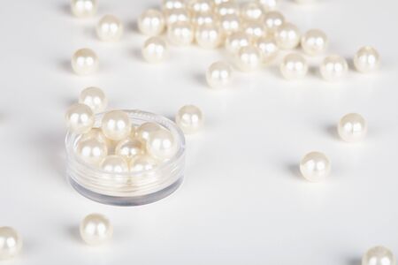 The artificial pearls are scattered light backgroundの写真素材