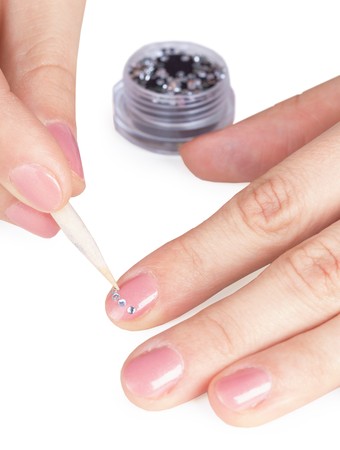 Process of gluing small a paste on a nail close upの写真素材