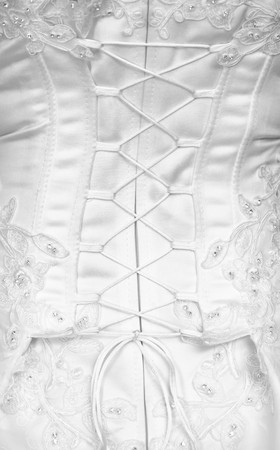 Lacing on a corset of a white dress of the bride - the rear viewの写真素材