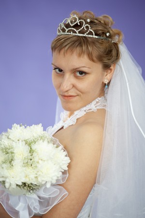 Portrait of the beautiful young woman - the bride on violet backgroundの写真素材