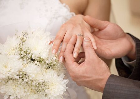 Hands of the groom and the bride with ring close upの写真素材