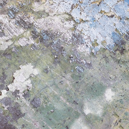 Square fragment of an old concrete wall with the rests of the damaged paintの写真素材