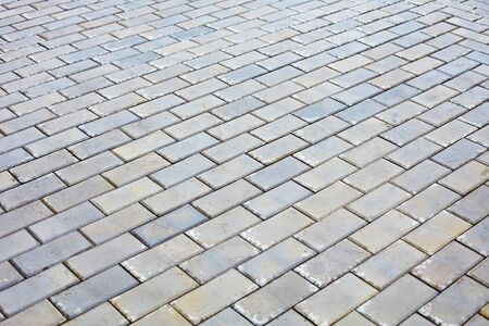 The surface is covered with gray bricksの写真素材