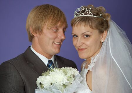 The bride and groom on a purple background closeupの写真素材