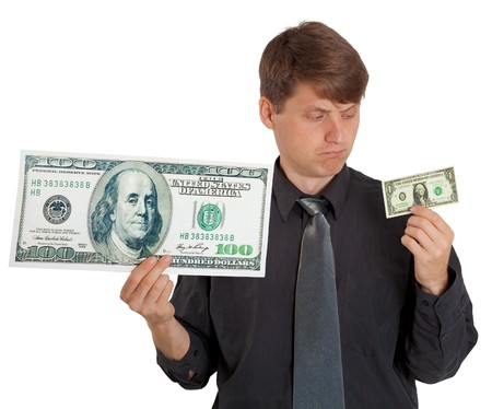 The businessman feels the difference between large and small money on white backgroundの写真素材