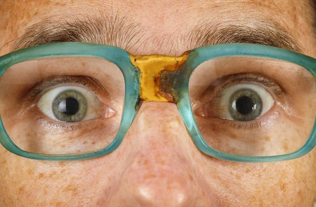 Eyes of the surprised person in old spectacles close upの写真素材