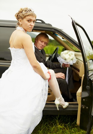 The sexual bride and the groom in the carの写真素材
