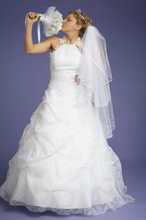The bride with a bouquet on a blue backgroundの写真素材