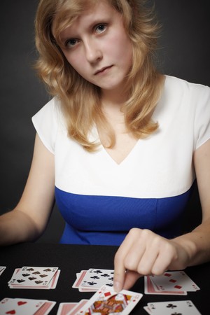 A young woman lays card game in the darkのeditorial素材