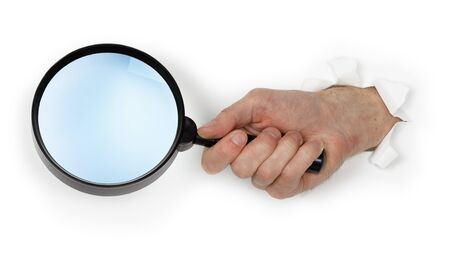 A large magnifying glass in hand isolated on white backgroundの写真素材