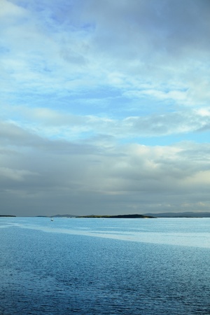 Vertical sea landscape with a horizon line in third of shotの写真素材