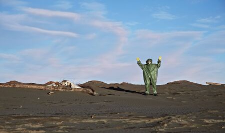 A man in overalls like an alien on desertの写真素材