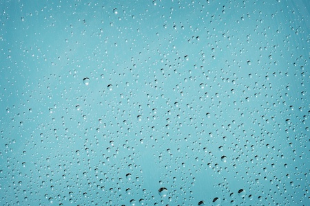 Blue background with tiny droplets of waterの写真素材