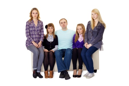 An ordinary family with many children sitting on the couchの写真素材