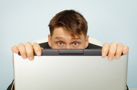 Accountant fear a tax audit - hiding behind a computerの写真素材