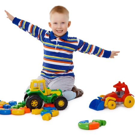 Little boy playing with colorful toys on the floorの写真素材