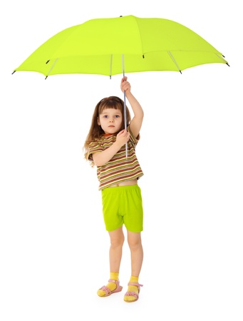 Child holds over his head a big green umbrellaの写真素材