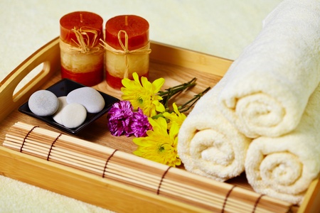 Still life on the spa. A tray of towels, candles and pebblesの写真素材
