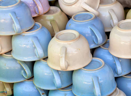 A large pile old-fashioned ceramic chamber pots on the marketの写真素材