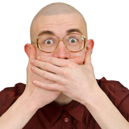 A young man holding back vulgar jokesの写真素材