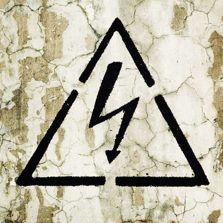 A warning sign painted on the wall - Electricityの写真素材
