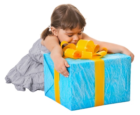 Happy child embraces large birthday gift isolated on white backgroundの写真素材