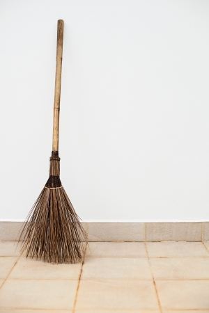 A large a broom near a white wallの写真素材