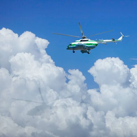 The helicopter is flying above the cloudsの写真素材