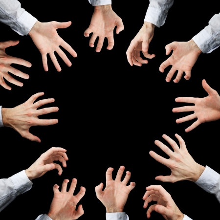 Hands stretching to something isolated on black backgroundの写真素材