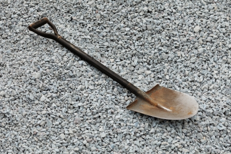 Old shovel lying on the gray gravelの写真素材
