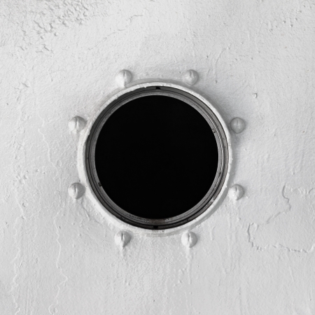 Old window at the gray wall of the vesselの写真素材