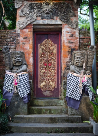 The gates of the old temple and stone guards  Indonesia, Bali の写真素材