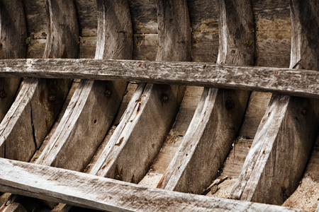 The skeleton of an old wooden fishing boat. Thailandの写真素材
