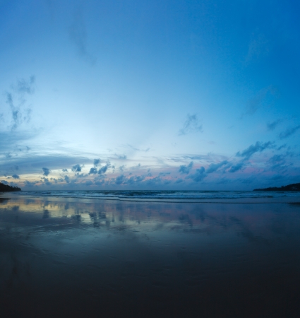 Evening on the beach at low tide. Beautiful reflection of cloudsの写真素材