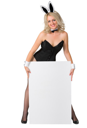 Beautiful blonde in a bunny suit with vertical banner on white backgroundの写真素材