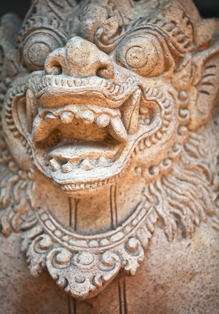 Muzzle of terrible mythical monster. Stone old statue from Indonesia, Bali islandの写真素材