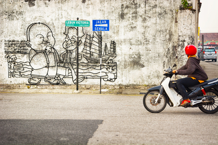 MALAYSIA, PENANG, GEORGETOWN - CIRCA JUL 2014: A simple mural explains a cultural and historical point of interest.のeditorial素材