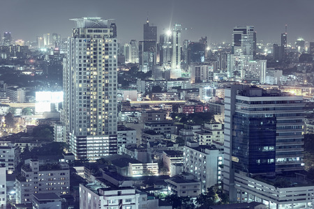 Modern downtown night scene, beautiful buildings, bright glowing lightsの写真素材