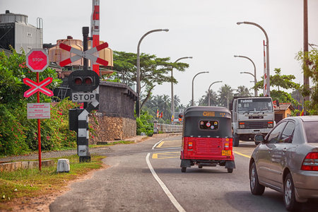 SRI LANKA - CIRCA APR 2013: traffic on the street stopped before moving train