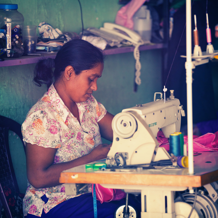 NUWARA ELIYA, SRI LANKA - CIRCA APR 2013: seamstress at work. Asian womanのeditorial素材