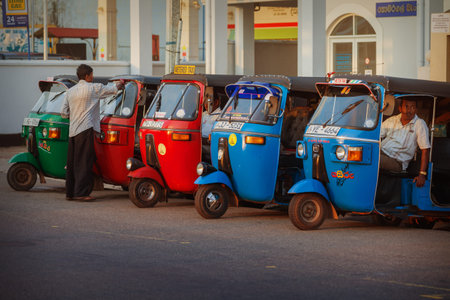 HIKKADUWA, SRI LANKA - CIRCA APR 2013: Taxi tuk-tuk with drivers drivers waiting for passengers....