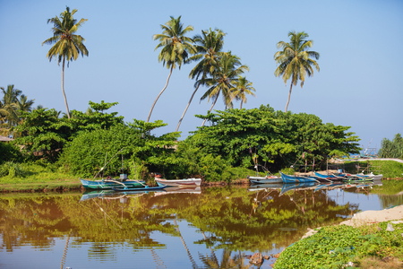 GALLE, SRI LANKA - CIRCA APR 2013: A small backwater with wooden boatsのeditorial素材