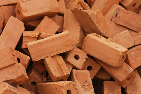 A pile of bricks from red clay. background. Close up shot