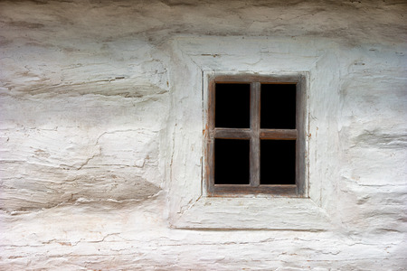 Ancient Ukrainian window on white wall. The house in an authentic village. Ukraine, Kiev, Porogovoの写真素材